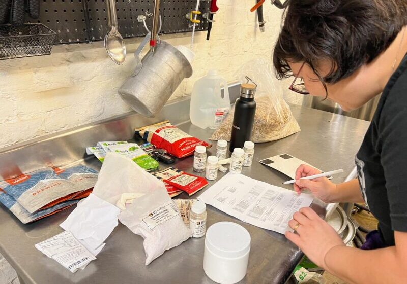 Photo of CHAOS brewer working on a recipe at her brew station.